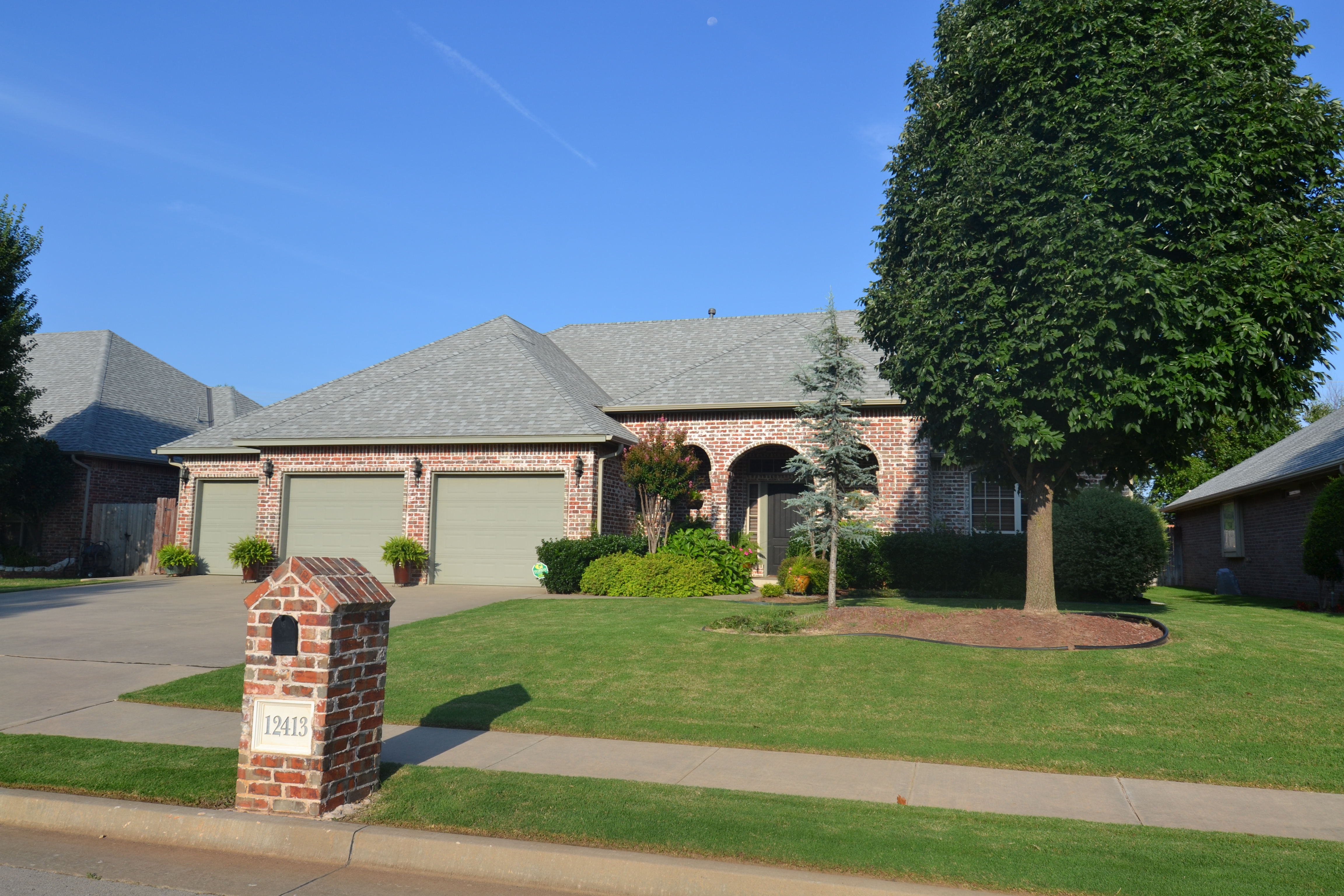 Brick custom home with mature landscaping