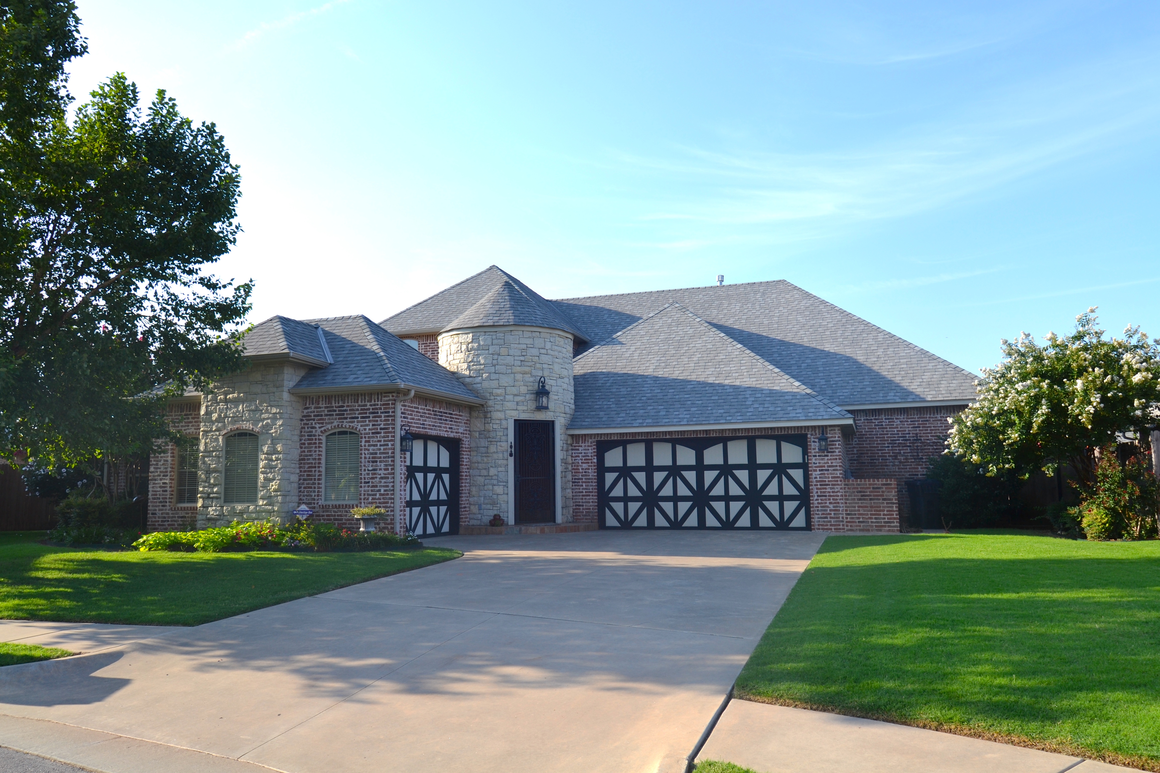 Custom Premier Dwellings home with stone turret and brick exterior
