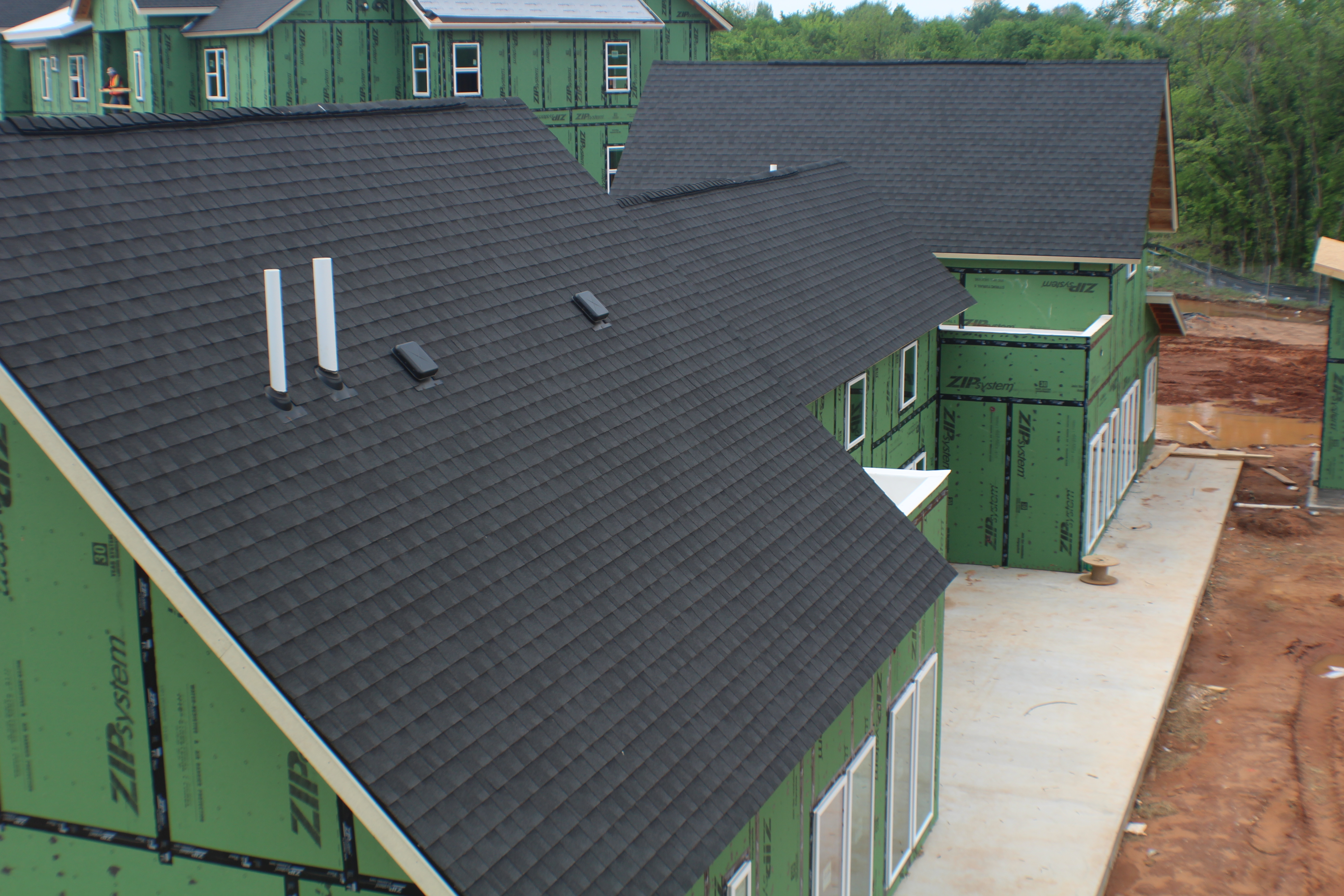 Aerial view of dark shingle roofing installation
